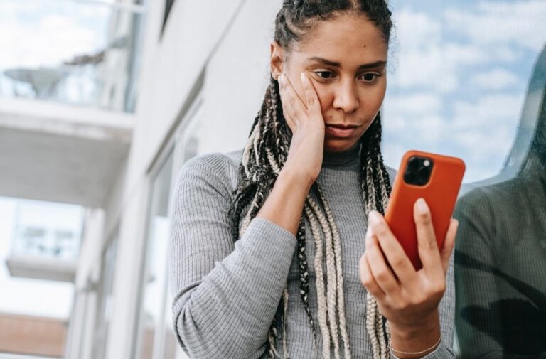 worried women looking at cell phone - hack