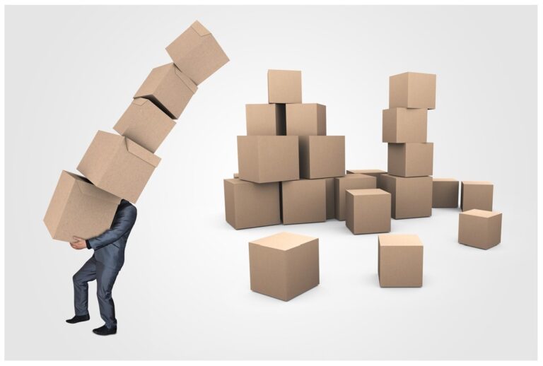 man in suite carrying boxes boxes on floor