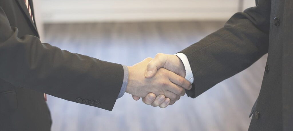 men in suites shaking hands