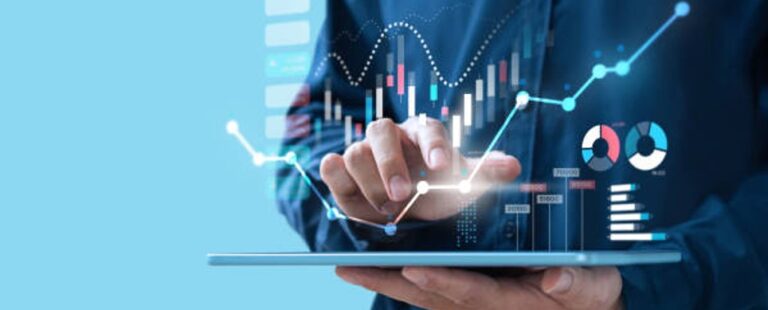 hand on tablet with graphs tables charts