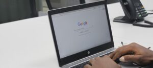 hands on hp laptop keyboard with google on screen