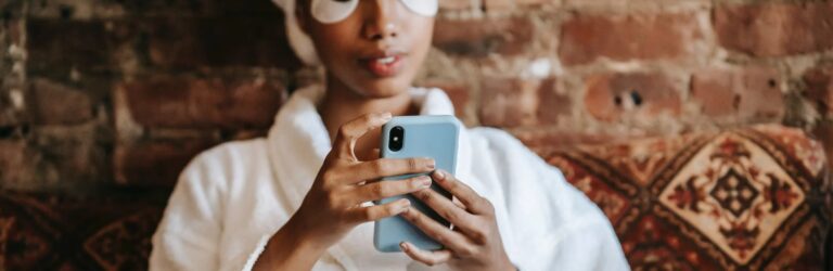 woman at spa using mobile phone relaxing