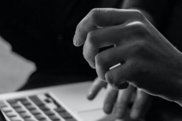 laptop computer on lap - black and white