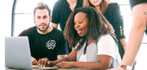 young UX team happily looking at laptop